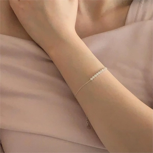 Detail of S925 sterling silver bracelet with seven zircon floral clusters on model wrist