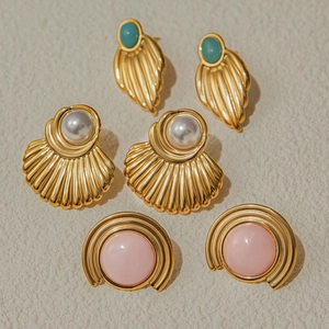 Three pairs of vintage gold earrings with faux pearls and colorful gemstones set
