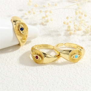 Detailed view of three 18K gold plated evil eye rings with blue, red, and turquoise stones