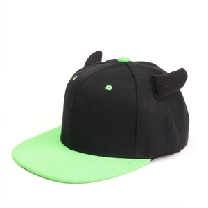 Detail of hip-hop flat brim hat with black body, green visor, and devil horns