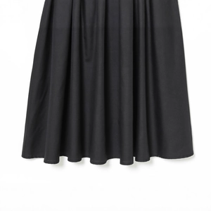 Chic black mini dress with elegant pleated hem design and high-quality fabric texture