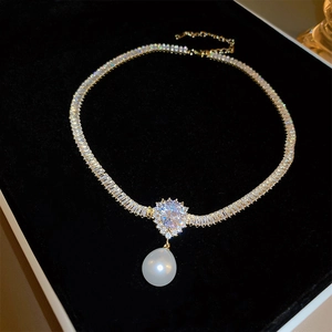 Elegant gold plated necklace with cubic zirconia links and a pear shaped pearl pendant
