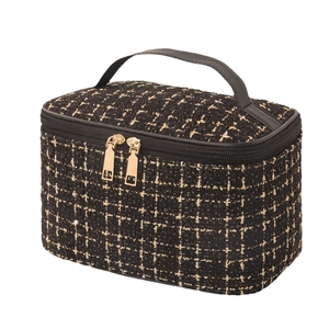 Quilted tweed makeup bag with gold hardware and top handle for travel organization
