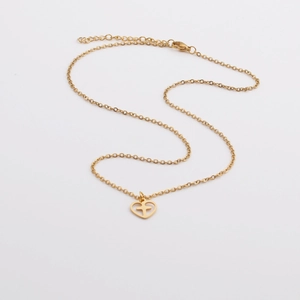Minimalist gold heart cross pendant necklace with adjustable chain on white background
