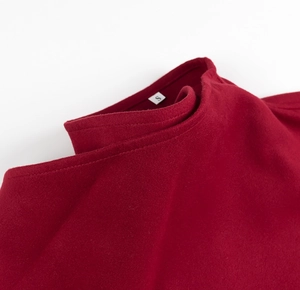 Macro detail of red wool coat collar with precise stitching and size S label