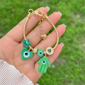 18K gold plated snake chain bracelet with green evil eye and Hamsa hand charms