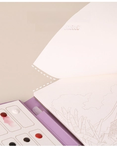 Detail of glue-bound watercolor book showing easy-to-tear pages and built-in paint palette