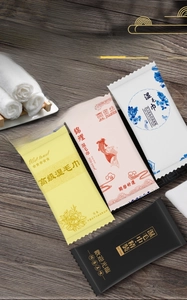 Macro view of individually wrapped wet towels in yellow, pink, blue and black packaging