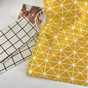 Detail of cotton linen placemats with geometric star and black grid patterns