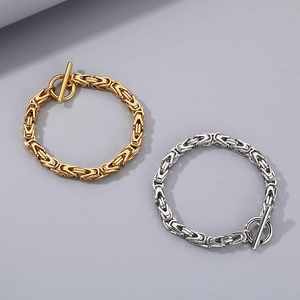 Detailed view of silver and gold Byzantine style chain bracelets with T-bar OT closure