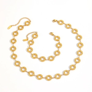 Macro detail of 18k gold plated stainless steel necklace and bracelet set with link rings