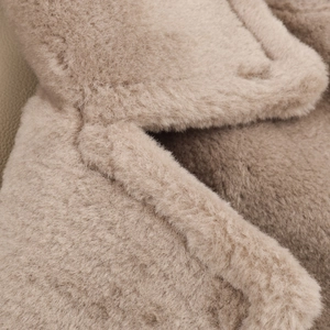 Close-up of the thick fleece texture and premium stitching on this beige lamb wool coat