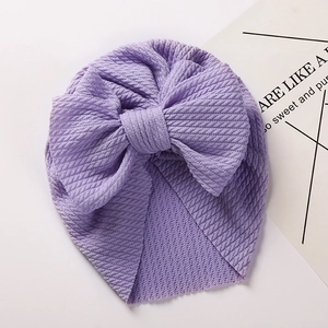 Detail of lavender baby turban featuring waffle texture and a large soft bow decoration