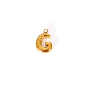 Close-up of polished gold-plated letter G pendant with a smooth metallic bubble finish