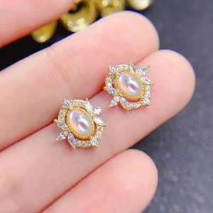 Oval faux moonstone stud earrings with marquise crystals in gold floral setting