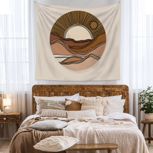 Detail showing bohemian tapestry with abstract sun and mountain landscape in earth tones