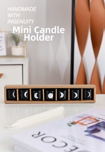Set of 7 black ceramic tea light holders with white moon phase designs in a kraft box