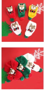 Detailed view of Christmas scarves with elk decor, bells and plush fabric texture