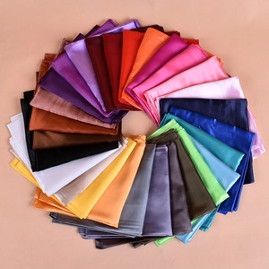 Close-up of colorful sequined paisley bandanas in a spiral arrangement for party wear
