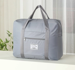 Macro detail of high-capacity gray waterproof travel bag with reinforced handles