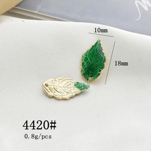 Macro shot of 10x18mm leaf charms in gold and green enamel for DIY jewelry making