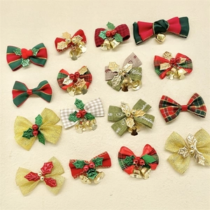 Detailed view of 16 assorted Christmas ribbon bows with bells and berries for DIY crafts