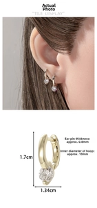 Detail view of gold hoop earrings with heart-shaped stone and technical size measurements