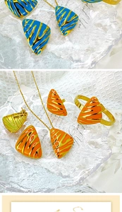 Detailed close-up of blue and orange enamel jewelry set with golden tiger stripe pattern