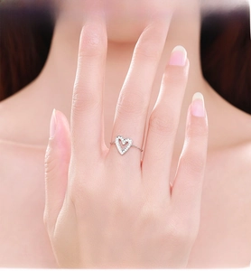 Primo piano dell'anello in argento S925 con cuore traforato e pavé sulla dita