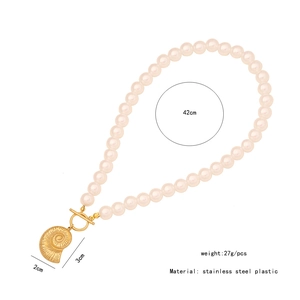 Detailed view of sea shell pendant on a pearl necklace with sizing and weight specs