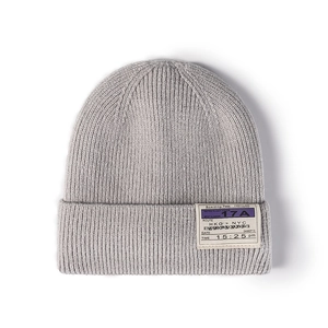 Light gray knit beanie with boarding pass patch on a clean white background