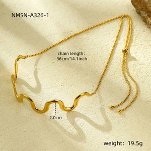 Detail view of gold wavy necklace with size markings and adjustable ball clasp closure