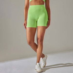 Detail of high-waist neon green seamless yoga shorts with ribbed tummy control waistband