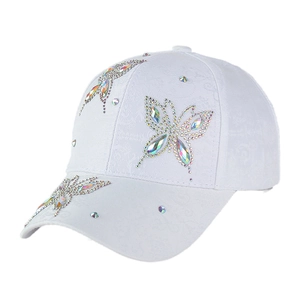 Close-up of sparkling rhinestone butterflies and crystals on white jacquard baseball cap