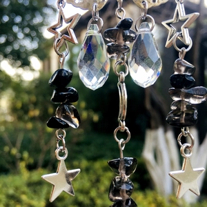 Close-up of butterfly suncatcher featuring crystal prisms and natural stone beads