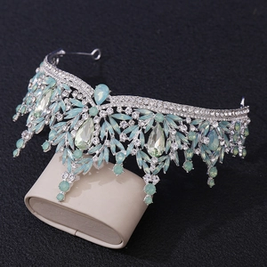 Macro detail of silver bridal crown with light green crystals and clear rhinestones