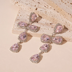 Detailed view of luxury pink crystal water drop earrings with silver tassels and zircon