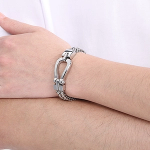 Macro detail of men's stainless steel double keel chain bracelet with a horseshoe clasp