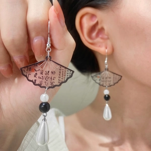 Detail of fan-shaped earring with calligraphy, hanging beads, and teardrop pearl