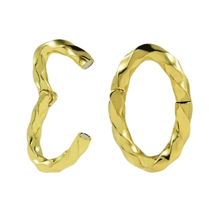 Polished golden twist hoop earrings with textured magnetic closure on white background