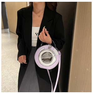 Detailed view of a unique purple washing machine-shaped round handbag with transparent window