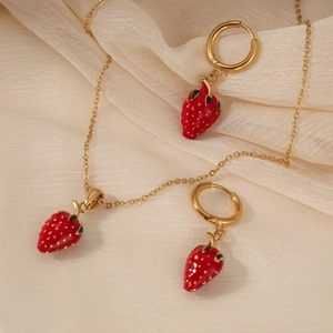 Cute strawberry jewelry set featuring red enamel pendants on gold necklaces and earrings