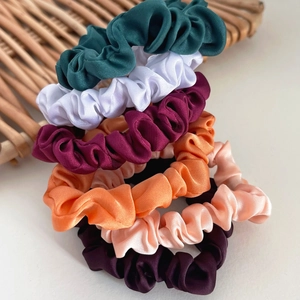 Set of 5 premium satin scrunchies in deep green, white, burgundy, orange, and purple
