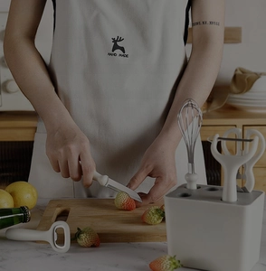 Detail of multi-functional kitchen gadget set with stainless steel blades and storage base