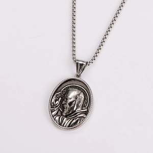 Detailed close-up of a silver vintage oval pendant with a relief portrait on a box chain