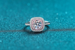 Macro detail of S925 silver ring featuring a round moissanite with pink diamond halo