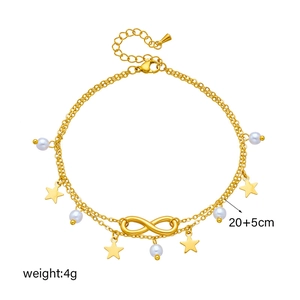 Gold-layered infinity and star charm bracelet with white faux pearls on white background