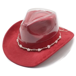 Detail of red suede cowboy hat featuring a decorative heart bead chain and curved brim