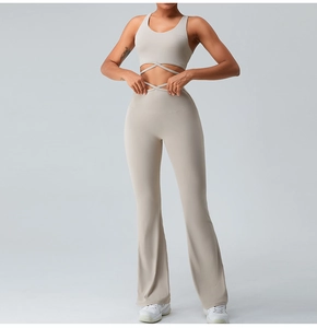 Detail of light apricot yoga set featuring racerback top with cross-strap hem and flared pants