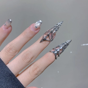 Detail of silver gothic armor rings with hollow vine patterns and sparkling rhinestones